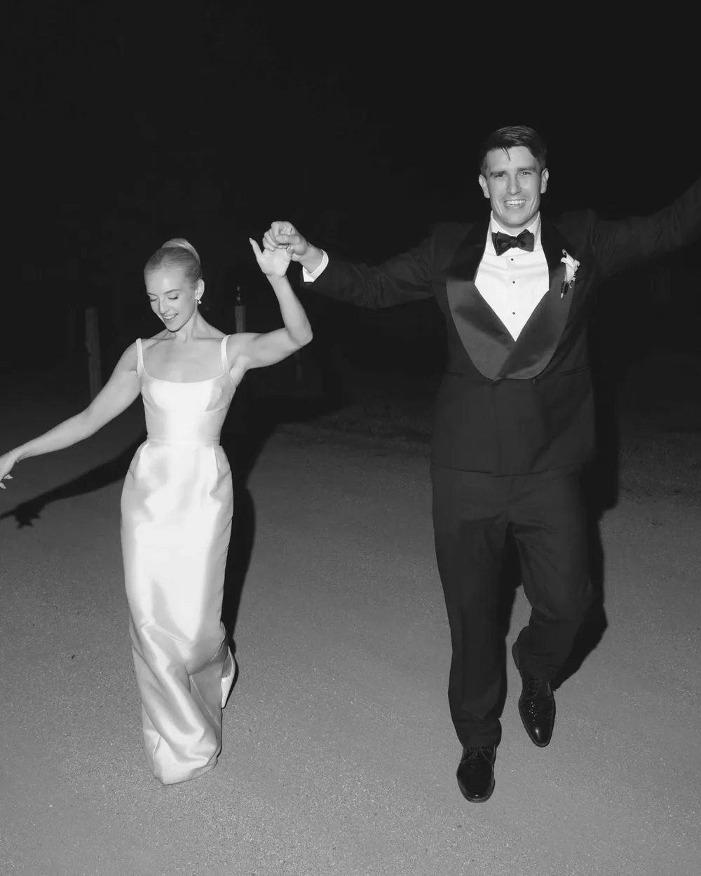 Bride and groom dancing at night in black and white
