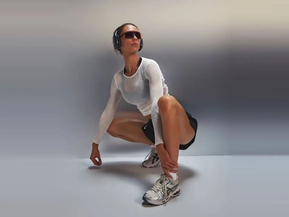 Jules crouched low in running kit and headphones, looking up